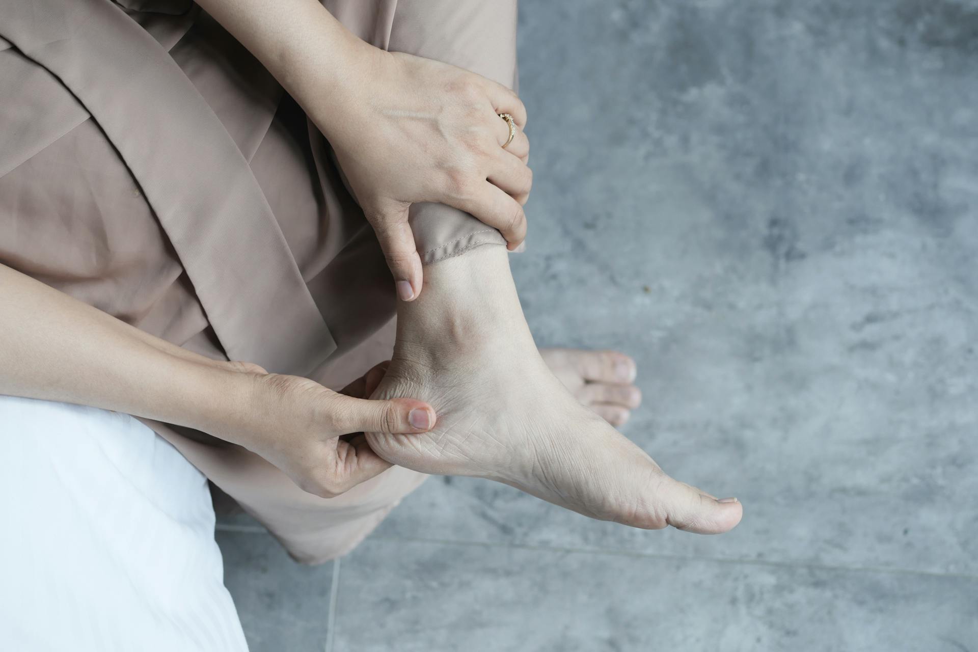 Close-up of a podiatrist performing a professional foot massage for pain relief.