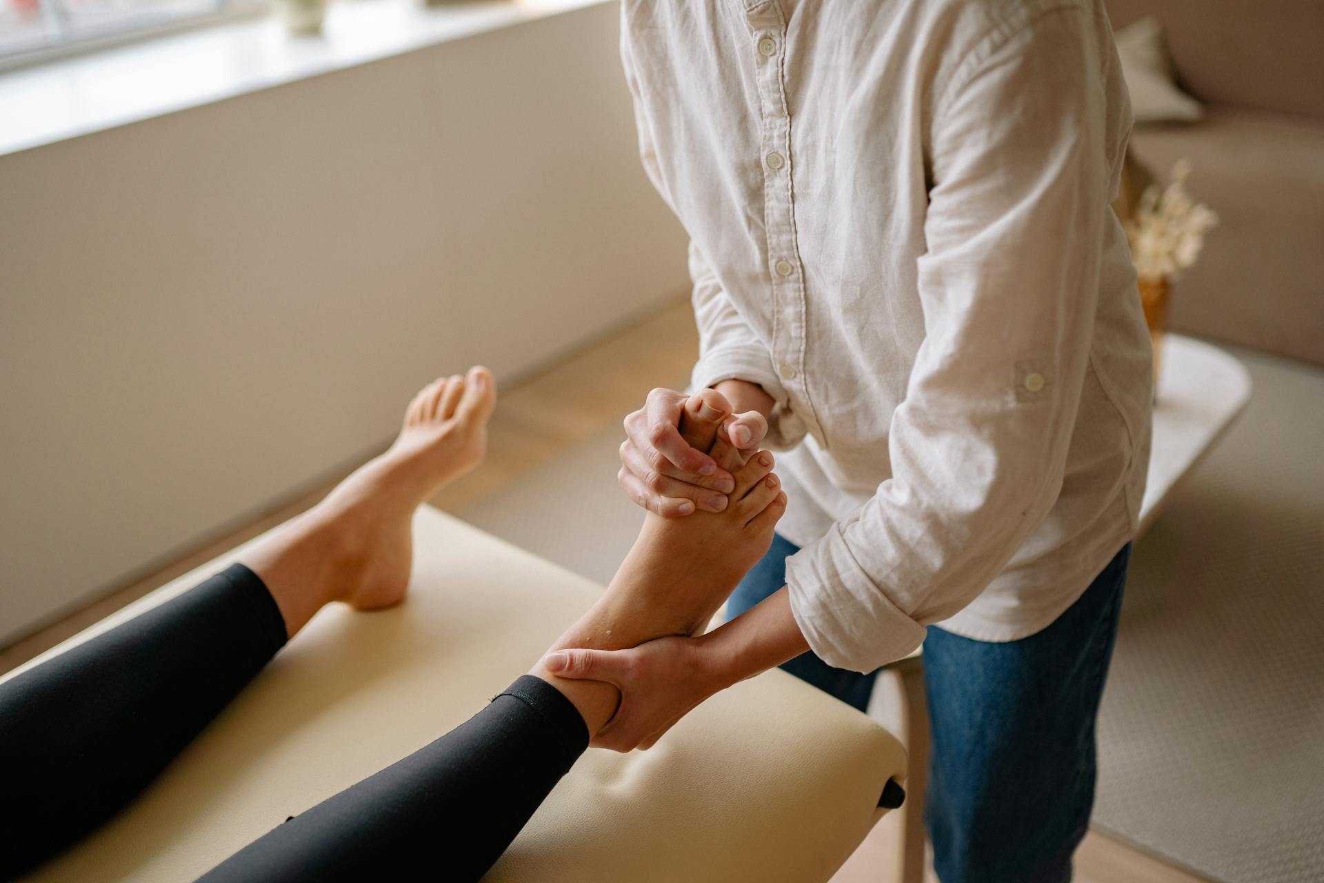 Close-up of a podiatrist performing a foot massage for pain relief and relaxation.